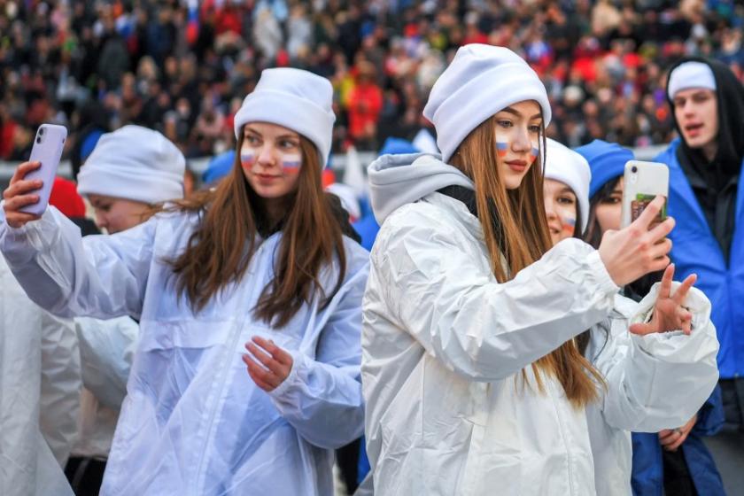 Russian teens looking at their phones.